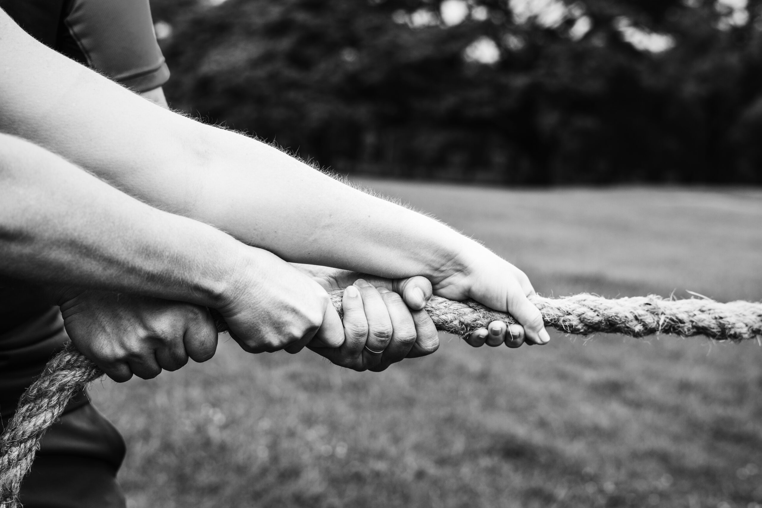 Hands pulling on rope in tug-of-war